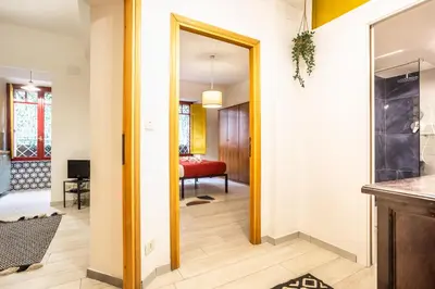 a hallway with a door leading to a living room at La Piccola Retró , urban color and comfort in Rome
