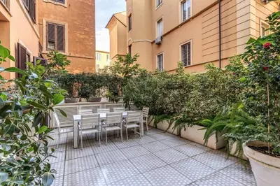 a courtyard with tables and chairs in a building at Luxury flat with terrace by historic center in Rome