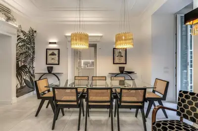 a dining room with a glass table and chairs at Luxury flat with terrace by historic center in Rome
