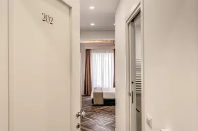 a room with a bedroom with a bed and a door at Effe Luxury Rooms in Rome