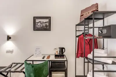 a room with a desk and a shelf with a table at Effe Luxury Rooms in Rome