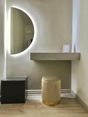 a room with a circular mirror and a stool at Rhome in Rome