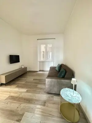 a living room with a couch and a table at Rhome in Rome