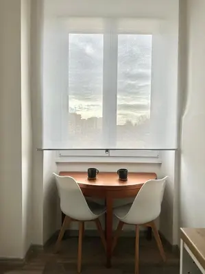 a table and two chairs in front of a window at Rhome in Rome