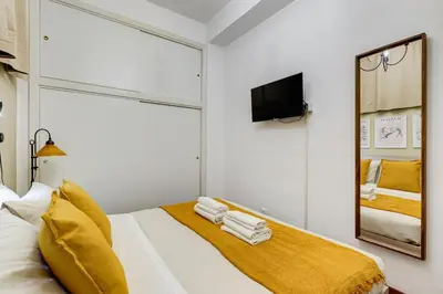 a white bedroom with a mirror and a bed at BDC - Central charming 2-Bdr! in Rome