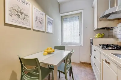 a kitchen with a table and some fruit on it at BDC - Central charming 2-Bdr! in Rome