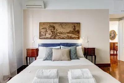 a bedroom with a large bed with a blue headboard at BDC - Central charming 2-Bdr! in Rome