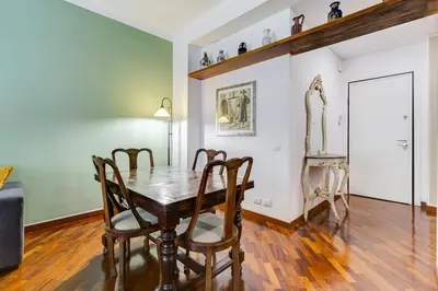 a dining room with a wooden table and chairs at BDC - Central charming 2-Bdr! in Rome