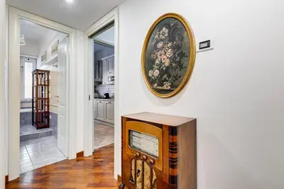 a room with a painting on the wall and a tv at BDC - Central charming 2-Bdr! in Rome