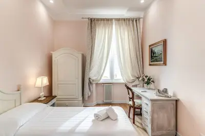 a bedroom with a bed and a desk and a window at Casa Vacanze Collina in Rome