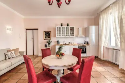 a living room with a table and red chairs at Casa Vacanze Collina in Rome