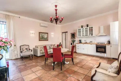a kitchen and living room with a table and chairs at Casa Vacanze Collina in Rome