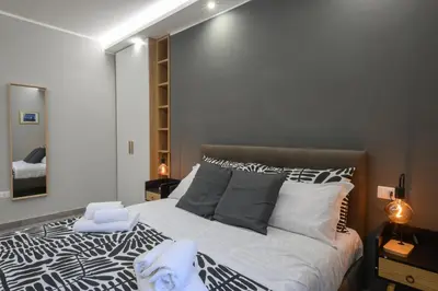 a bedroom with a bed with a black and white comforter at Domus Maria in Rome