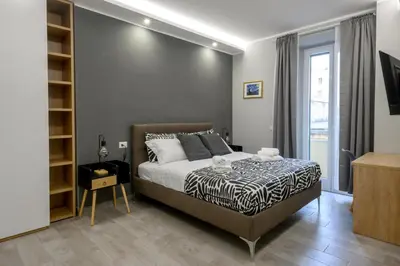 a bedroom with a large bed and a window at Domus Maria in Rome