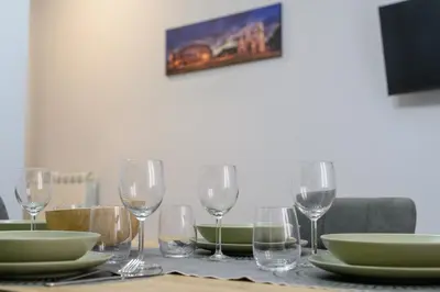 a table with wine glasses and plates on it at Domus Maria in Rome