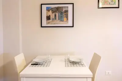 a white table with two chairs and a picture on the wall at Dreaming in Trastevere in Rome