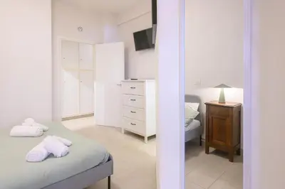 a bedroom with a bed and a dresser and a mirror at Dreaming in Trastevere in Rome