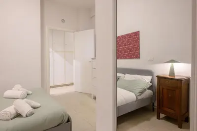 a bedroom with a bed and a mirror at Dreaming in Trastevere in Rome