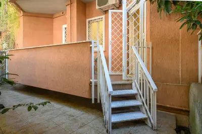 a staircase leading to a room with orange walls at Dreaming in Trastevere in Rome
