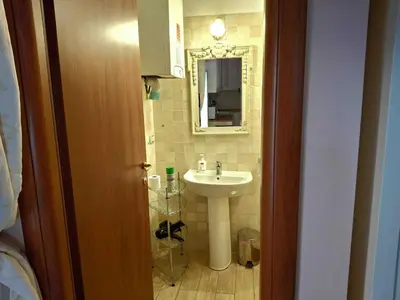 a bathroom with a sink and a mirror at Firenze 32 at the Opera House in Rome