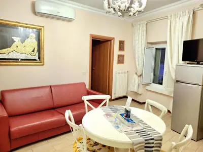 a living room with a red couch and a table at Firenze 32 at the Opera House in Rome