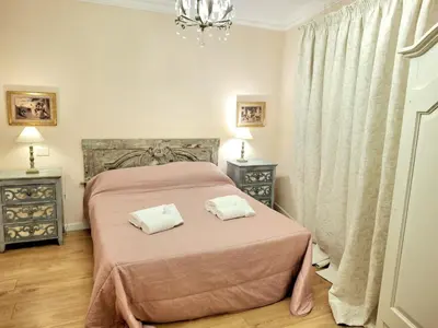 a bedroom with a pink bed with two towels on it at Firenze 32 at the Opera House in Rome