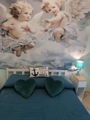 a bedroom with a painting of angels on the ceiling at Le chat bleu in Rome