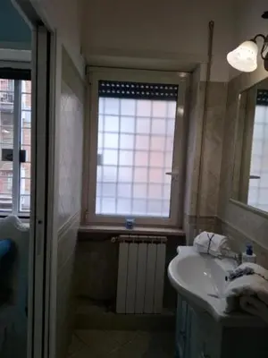 a bathroom with a sink and a window at Le chat bleu in Rome