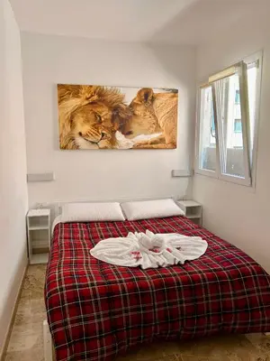 a bedroom with a bed with two lions on the wall at Trastevere Ripa Apartments in Rome