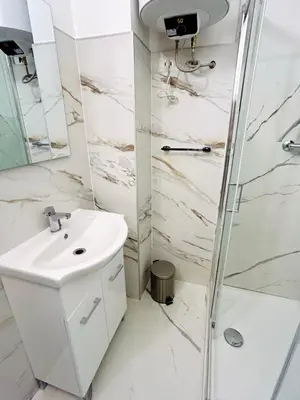 a bathroom with a sink and a shower at Trastevere Ripa Apartments in Rome