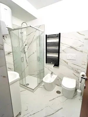 a bathroom with a shower and a toilet and a sink at Trastevere Ripa Apartments in Rome