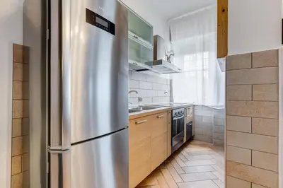 a stainless steel refrigerator in a small kitchen at Ferravilla Apt, 2 min to subway! in Rome
