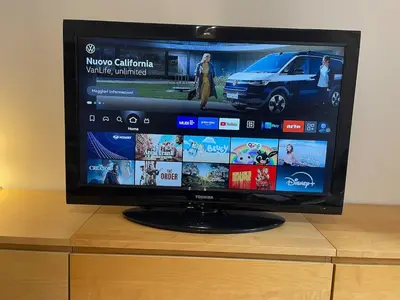 a flat screen tv sitting on top of a dresser at Theo's House in Rome Ostiense in Rome