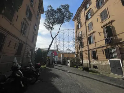a group of motorcycles parked in an alley between two buildings at Theo's House in Rome Ostiense in Rome