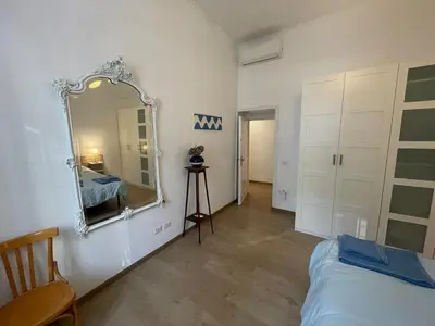 a bedroom with a mirror on the wall and a bed at Theo's House in Rome Ostiense in Rome