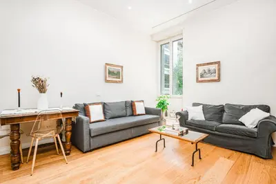 a living room with two couches and a table at DAMA APARTMENT 2 camere da letto 2 bagni con doccia in Rome