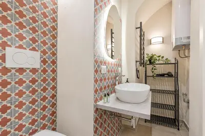 a bathroom with a sink and a mirror at Rome As You Feel - Charming Space at Torre Argentina in Rome