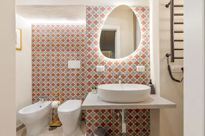 a bathroom with a sink and a toilet and a mirror at Rome As You Feel - Charming Space at Torre Argentina in Rome