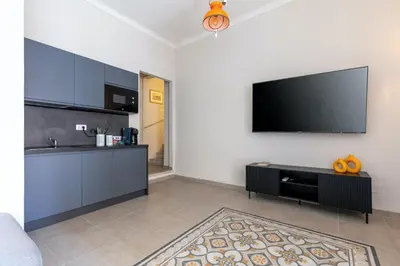 a living room with a flat screen tv on a wall at Rome As You Feel - Charming Space at Torre Argentina in Rome