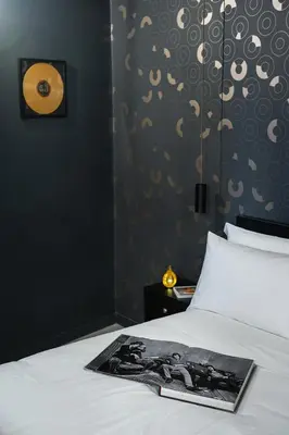 a bedroom with a bed with a magazine on it at SONUS Colosseum in Rome