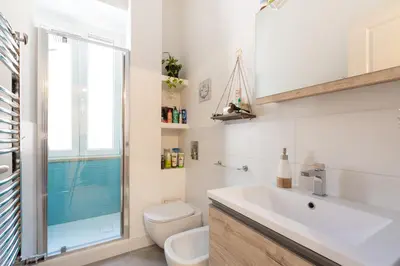 a bathroom with a sink and a toilet and a window at GuestHost - San Giovanni Comfy Apartment in Rome
