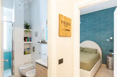 a bathroom with a bed and a toilet and a sink at GuestHost - San Giovanni Comfy Apartment in Rome