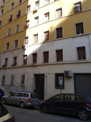 two cars parked in front of a building at GuestHost - San Giovanni Comfy Apartment in Rome