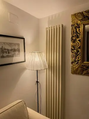 a room with a radiator and a lamp and a picture at Rooftop view house near Piazza Navona in Rome