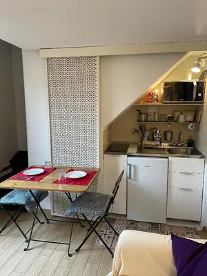 a small kitchen with a table and chairs in a room at Rooftop view house near Piazza Navona in Rome