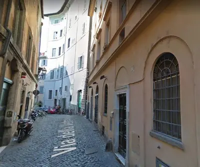 an empty alley with buildings and a motorcycle on a street at Rooftop view house near Piazza Navona in Rome
