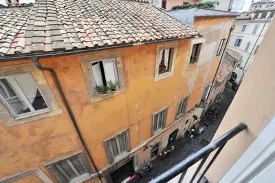 an orange building with windows and a roof at Rooftop view house near Piazza Navona in Rome