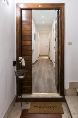 a hallway with a mirror in front of a door at St Peter Manor 2 - St Peter Manor 3 in Rome
