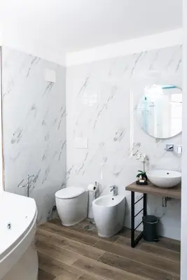 a white bathroom with two toilets and a sink at St Peter Manor 2 - St Peter Manor 3 in Rome