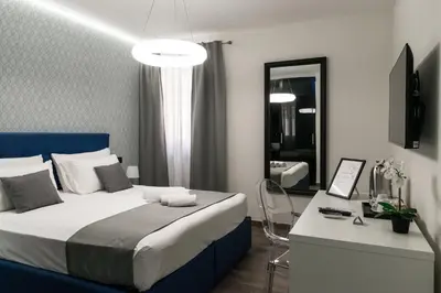 a bedroom with a bed and a desk and a room with at St Peter Manor 2 - St Peter Manor 3 in Rome